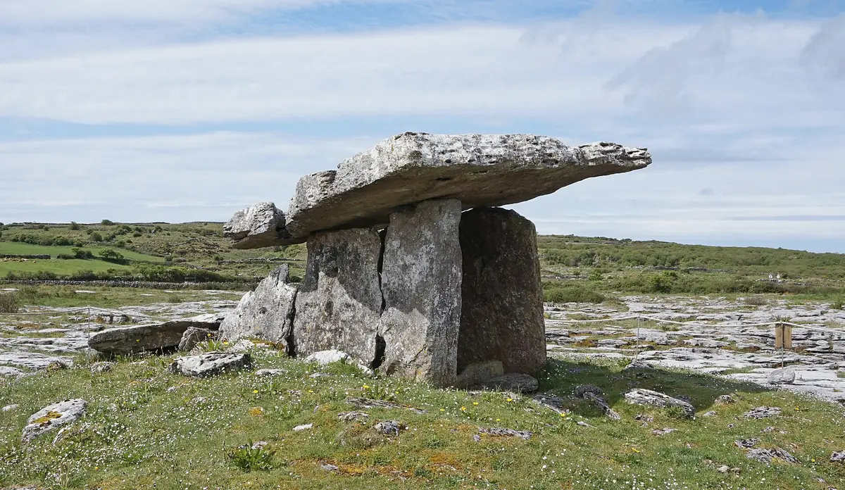 Il dolmen di Poulnabrone, grande lastra di pietra su due pietre verticali, nel paesaggio calcareo del Burren